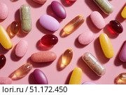 Medicine Pills on Pink Background. Medicinal Capsules and Tablets for Health. Vitamin and health supplement, colorful pills various types multivitamins and tablets. Antiviral, pharmaceutical products. Стоковое AI-изображение, AI-художник Марина Демидюк / Фотобанк Лори