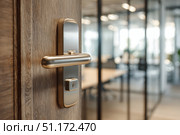Doorknob. Metal door handle lock and latch of brass on veneer doors. Door wooden half opening through interior bedroom background, selective focus. Modern trends in interior design. Close-up. Стоковое AI-изображение, AI-художник Марина Демидюк / Фотобанк Лори