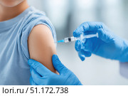 Child receiving a vaccination. Little boy in face mask in doctor's office is vaccinated. Kid giving injection shot. Syringe with covid-19, coronavirus, flu vaccine. Dangerous infectious disease, MPOX. Стоковое AI-изображение, AI-художник Марина Демидюк / Фотобанк Лори