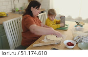 Grandma teaching grandson to make pizza dough. Happy Caucasian granny and grandchild making pizza in kitchen. Cute boy cooking together with grandmother. Family leisure. Multi generation family video. Стоковое видео, видеограф Марина Демидюк / Фотобанк Лори