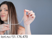 Beauty and care young woman with thick strands after professional hair extension procedure in modern beauty salon. Стоковое фото, фотограф Svetlana Golovco / Фотобанк Лори