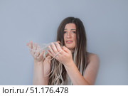 Sad young woman holding hairbrush with fallen strands worried about hair breakage and hair loss problem. Стоковое фото, фотограф Svetlana Golovco / Фотобанк Лори