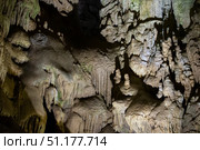 The cave is karst, amazing view of stalactites and stalagnites illuminated by bright light, a beautiful natural attraction in a tourist place. Стоковое фото, фотограф Лазаренко Светлана / Фотобанк Лори