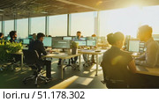 A team of professionals collaborates in a modern office, focusing on coding while enjoying the warm afternoon sunlight. Стоковое AI-видео, аниматор Данила Большаков / Фотобанк Лори