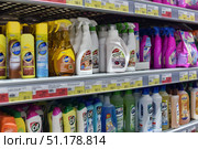 A store rack with household chemicals and cleaning products. Well-known brands of cleaning products such as Pronto, Vanish, Cif, Glorix, Emsal and others are neatly arranged on the shelves. Furniture aerosols, universal cleaning liquids, floor cleaning concentrates and vacuum cleaners are visible. The packaging is varied in shape and color: sprays, spray bottles, plastic bottles and canisters. The shelves also have price tags indicating the cost of goods in rubles. The atmosphere of the photo conveys the image of a modern supermarket, where a wide selection of products for the home and cleaning is presented. (2015 год). Редакционное фото, фотограф Анна Кривицкая / Фотобанк Лори