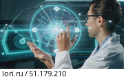 A researcher engages with a holographic interface, interacting with floating data points in a modern lab setting. Стоковое AI-видео, аниматор Данила Большаков / Фотобанк Лори