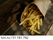 French fries in paper box on wooden background. Стоковое фото, фотограф Маргарита Кирьякова / Фотобанк Лори