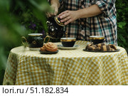 Tea party. Hands pouring tea into mug outdoors. Стоковое фото, фотограф Маргарита Кирьякова / Фотобанк Лори