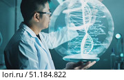 A researcher examines advanced DNA modeling technology, highlighting significant scientific advancements in genetics. Стоковое AI-видео, аниматор Данила Большаков / Фотобанк Лори