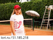Teenage Girl Focuses on Improving Her Game During Outdoor Tennis Practice on a Sunny Day. Стоковое фото, фотограф Aleksandr Golubev / Фотобанк Лори