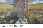 Baikal Lake shore. Video of offerings and gifts from tourists at sacred marble stone in labyrinth of the place of power on Olkhon Island. Tourists leave souvenirs, coins, painted stones here. Стоковое видео, видеограф Виктория Катьянова / Фотобанк Лори