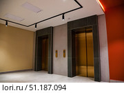 Golden Portals to the Upper Levels in a Modern Building Lobby. Стоковое фото, фотограф Aleksandr Golubev / Фотобанк Лори