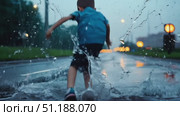 The gentle rainfall creates a serene mood as it collects on the pavement, enhancing the nighttime urban ambiance. Стоковое AI-видео, аниматор Данила Большаков / Фотобанк Лори