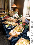 Buffet hotel restaurant, coffee break event food on wooden plates stand on table. Стоковое фото, фотограф Spirit River / Фотобанк Лори