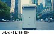 An autonomous delivery robot makes its way through bustling city streets, carefully maneuvering around cars and pedestrians at midday. Стоковое AI-видео, аниматор Данила Большаков / Фотобанк Лори