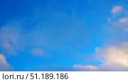 Witness a breathtaking view of a brilliant blue sky kissed by gentle white clouds. The tranquil atmosphere evokes a sense of peace and wonder in nature canvas. Стоковое видео, видеограф Юлия Петровская / Фотобанк Лори