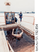 Saint Petersburg, Russia, 19 January 2022, People dip font on Orthodox Epiphany. Редакционное фото, фотограф Spirit River / Фотобанк Лори