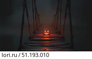 Glowing jack-o'-lantern on a misty bridge, creating an eerie Halloween atmosphere at night. Стоковое AI-видео, аниматор Данил Руденко / Фотобанк Лори
