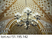 St. Petersburg, Russia - May 27, 2021: Hermitage Museum, large chandelier with gilding for hall lighting. Palace interior details. Редакционное фото, фотограф Наталия Кирсанова / Фотобанк Лори