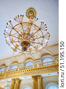 St. Petersburg, Russia - May 27, 2021: Hermitage Museum, large chandelier with gilding for hall lighting. Palace interior details. Редакционное фото, фотограф Наталия Кирсанова / Фотобанк Лори