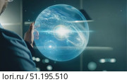 A scientist examines a captivating holographic projection of cosmic phenomena in a modern laboratory environment, showcasing cutting-edge research. Стоковое AI-видео, аниматор Данила Большаков / Фотобанк Лори