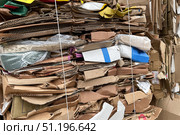 A stack of cardboard, paper and waste paper before shredding at a waste recycling plant. The concept of ecology and recycling. Стоковое фото, фотограф Регина Ерофеева / Фотобанк Лори
