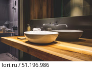 Modern bathroom with wooden vanity and vessel sink in minimalist design. Стоковое AI-изображение, AI-художник Zakharova Natasha / Фотобанк Лори