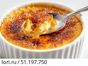 Creme brulee. dessert with caramel crust. Elegant Gourmet Dessert with Caramelized Sugar Crust. French vanilla cream. Eating Creme Brulee with Spoon. Cracking caramel. Delicious Sweet. Catalan cream. Стоковое AI-изображение, AI-художник Марина Демидюк / Фотобанк Лори
