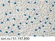 White cat litter round particles surface with small blue colored particles, top view. Granules of pet white-gray litter background. Dog litter texture backdrop with small dots. Flat lay, copy space. Стоковое AI-изображение, AI-художник Марина Демидюк / Фотобанк Лори