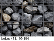 Gabion wall. Abstract architectural background of rough retaining wall made from rocks in steel cage gabion baskets. Retaining wall gabion basket, caged stones textured backdrop. Modern granite rubble. Стоковое AI-изображение, AI-художник Марина Демидюк / Фотобанк Лори