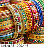 Colorful Bangles and Bracelets Displayed in a Market Stall. Generative AI. Стоковое AI-изображение, AI-художник Roman Zavorotny / Фотобанк Лори