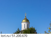 Magnitogorsk, Russian Federation - August 24, 2025: Church of the Intercession of the Most Holy Theotokos with golden dome against clear blue sky, showcasing architectural beauty and spiritual significance. Редакционное фото, фотограф Ирина Ручушкина / Фотобанк Лори