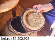 A hand with a lid from a wicker basket. Reed weaving. Стоковое фото, фотограф Наталия Кирсанова / Фотобанк Лори
