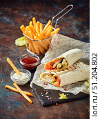 Eastern traditional shawarma, and French fries with sauces on slate. Стоковое фото, фотограф Ирина Буракова / Фотобанк Лори