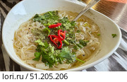 On a black background, flat lay, Vietnamese fo bo soup with quail egg, meat and noodles. Стоковое фото, фотограф Zita Khasanova / Фотобанк Лори