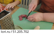 Female butcher cut raw meat with sharp knife at home kitchen. Woman cutting the chicken fillet in pieces for cooking. Preparing chopping food. Split poultry breast. Healthy lean meat, low cholesterol. Стоковое видео, видеограф Марина Демидюк / Фотобанк Лори