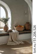 Cozy Nook With Fruits and Pottery in a Sunlit Room of a Rustic Home. Стоковое AI-изображение, AI-художник Юлия Гапеенко / Фотобанк Лори