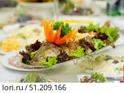 The food in the restaurant fish sturgeon on the tray is beautifully decorated. Стоковое фото, фотограф Наталия Кирсанова / Фотобанк Лори