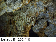 A wild cave inside. Stalactites and stalagmites. Speleology and surveys. Стоковое фото, фотограф Наталия Кирсанова / Фотобанк Лори