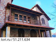 Stepantsminda, Georgia. - November 05, 2023: Carved wooden balcony of a traditional Georgian house. Редакционное фото, фотограф Наталия Кирсанова / Фотобанк Лори