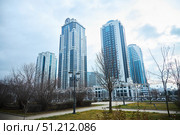 Grozny, Russia. - January 02, 2024: An urban landscape with a skyscraper in the middle. The sky is blue and the sun is shining. The Chechen Republic. Редакционное фото, фотограф Наталия Кирсанова / Фотобанк Лори
