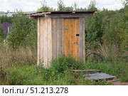 There's a wooden toilet outside the house. Стоковое фото, фотограф Александр Поташев / Фотобанк Лори