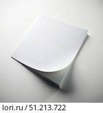 A Single Sheet of Paper Lies Flat on a White Surface With One Corner Flipped Up. Generative AI. Стоковое AI-изображение, AI-художник Roman Zavorotny / Фотобанк Лори