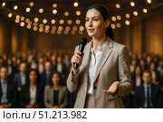 A Confident Speaker Engages an Enthusiastic Audience in a Well-Lit Conference Hall, Demonstrating Leadership and Communication Skills. Стоковое AI-изображение, AI-художник Башкирова Анна / Фотобанк Лори