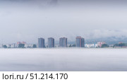 In a tranquil morning setting, fog blankets the residential neighborhood along the Yenisei River in Krasnoyarsk. Стоковое фото, фотограф Владимир Разгуляев / Фотобанк Лори