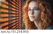 A young woman reflects on life while sitting by the window, warm sunlight casting patterns around her, creating a peaceful atmosphere. Стоковое AI-видео, аниматор Данила Большаков / Фотобанк Лори