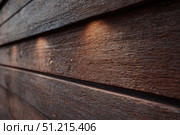 Modern brown wood plank texture. Fiber cement siding. Exterior of composite wall. Plastic material is eco-friendly polymer panels in rows. Wooden grain surface. Hollow WPC boards. Dark oak color. PE. Стоковое AI-изображение, AI-художник Марина Демидюк / Фотобанк Лори