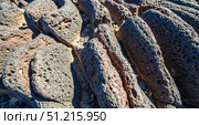 Abstract geology background with rounded volcanic rock texture, closeup of porous lava stone formation for powerful nature wallpaper or design element concept. Стоковое фото, фотограф Павел Муравьев / Фотобанк Лори