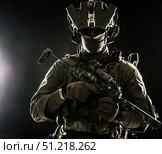 Serviceman equipped with modern weapons, studio portrait on black background. Oleg Zabielin / Stocktrek Images/TASS. Стоковое фото, агентство ТАСС / Фотобанк Лори