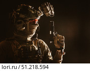 Studio portrait of soldier wearing a mask, helmet with night vision device, and armed with service pistol. Oleg Zabielin / Stocktrek Images/TASS. Стоковое фото, агентство ТАСС / Фотобанк Лори